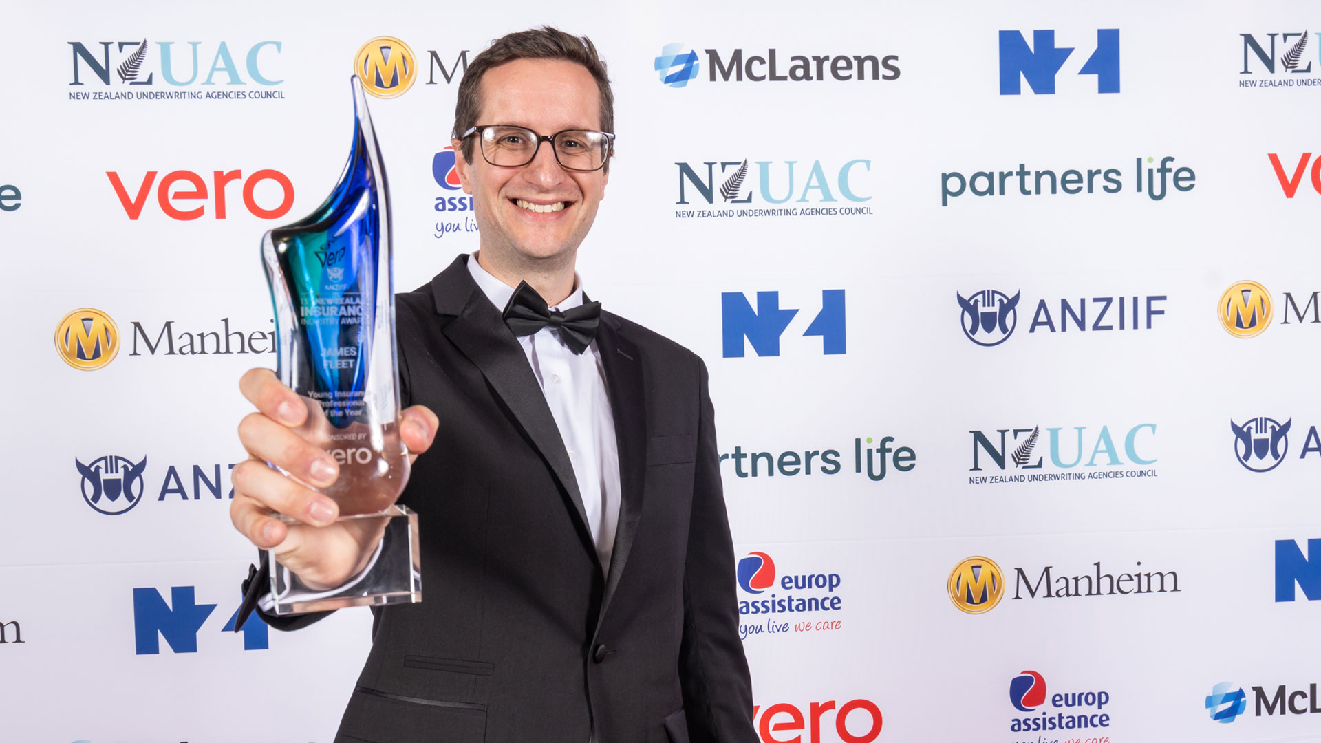 Fidelity Life's James Fleet holds out his 2025 ANZIIF award